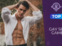Jeune homme musclé sous la pluie portant une chemise blanche ouverte, regard intense face à l’objectif, avec des gouttes d’eau illuminées en arrière-plan dans une ambiance sensuelle et cinématographique.